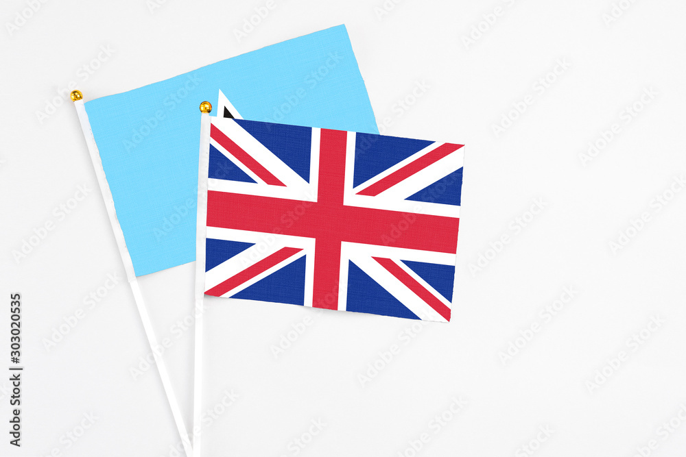 United Kingdom and Saint Lucia stick flags on white background. High quality fabric, miniature national flag. Peaceful global concept.White floor for copy space. United Kingdom and Saint Lucia stick flags on white background. High quality fabric, miniature national flag. Peaceful global concept.White floor for copy space.