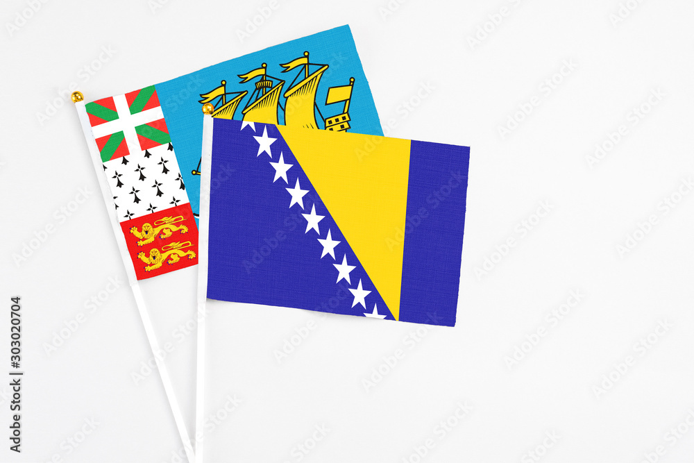Bosnia Herzegovina and Saint Pierre And Miquelon stick flags on white background. High quality fabric, miniature national flag. Peaceful global concept.White floor for copy space. Bosnia Herzegovina and Saint Pierre And Miquelon stick flags on white background. High quality fabric, miniature national flag. Peaceful global concept.White floor for copy space.