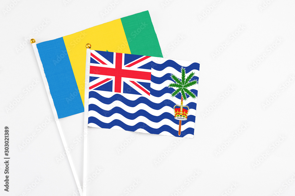Fototapeta premium British Indian Ocean Territory and Saint Vincent And The Grenadines stick flags on white background. High quality fabric, miniature national flag. Peaceful global concept.White floor for copy space.