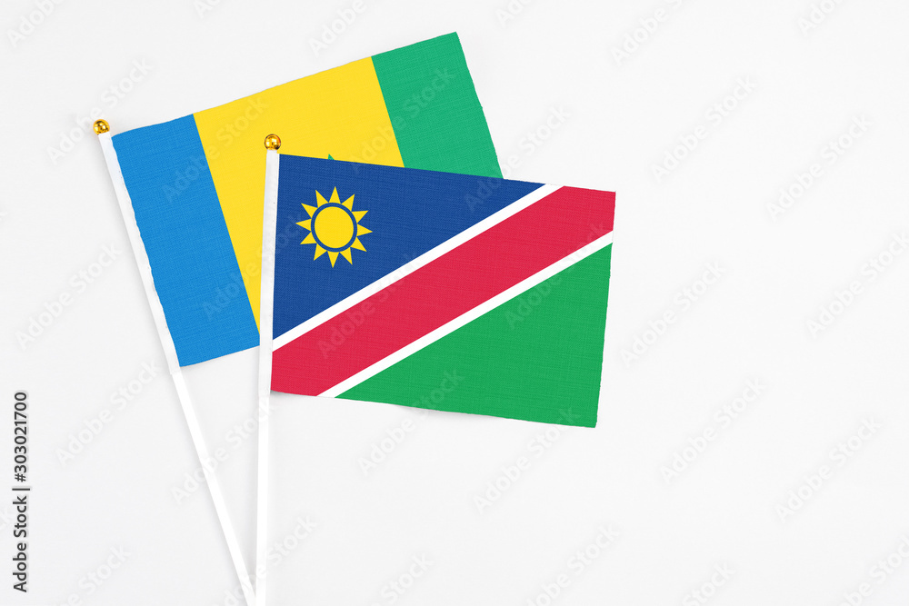 Namibia and Saint Vincent And The Grenadines stick flags on white background. High quality fabric, miniature national flag. Peaceful global concept.White floor for copy space. Namibia and Saint Vincent And The Grenadines stick flags on white background. High quality fabric, miniature national flag. Peaceful global concept.White floor for copy space.