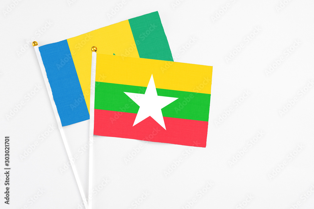 Myanmar and Saint Vincent And The Grenadines stick flags on white background. High quality fabric, miniature national flag. Peaceful global concept.White floor for copy space. Myanmar and Saint Vincent And The Grenadines stick flags on white background. High quality fabric, miniature national flag. Peaceful global concept.White floor for copy space.