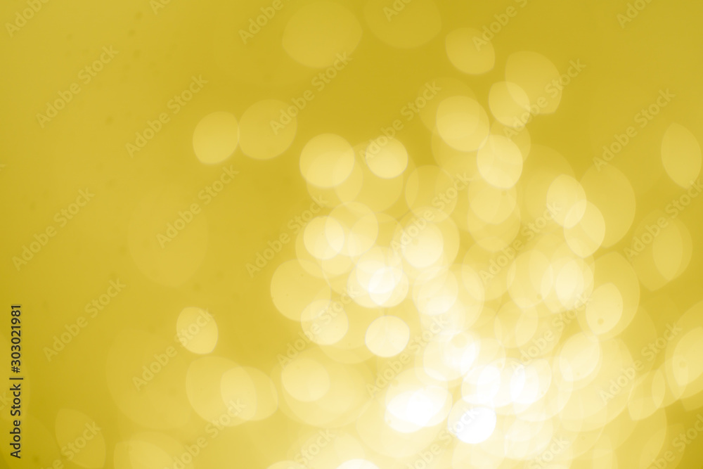 Obraz premium Yellow Gold Festive Christmas Beautiful abstract Background with bokeh lights. Holiday Texture with copy space. Can be used as Wallpaper, filling for a website, defocused