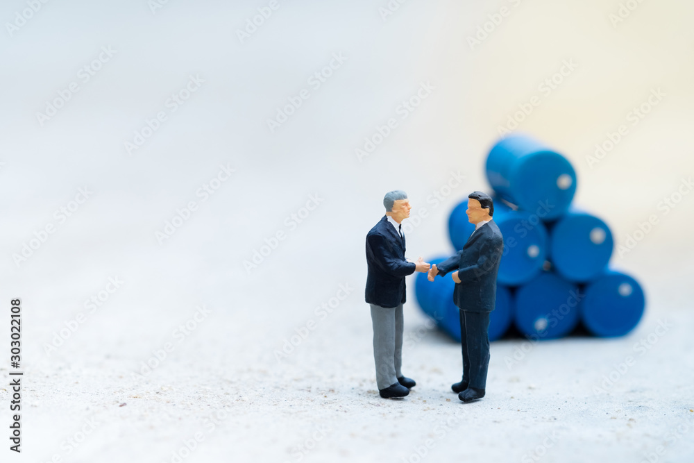 Miniature People : Two business man standing in front of drums pile with copy space, industrial concept, use as wallpaper Miniature People : Two business man standing in front of drums pile with copy space, industrial concept, use as wallpaper