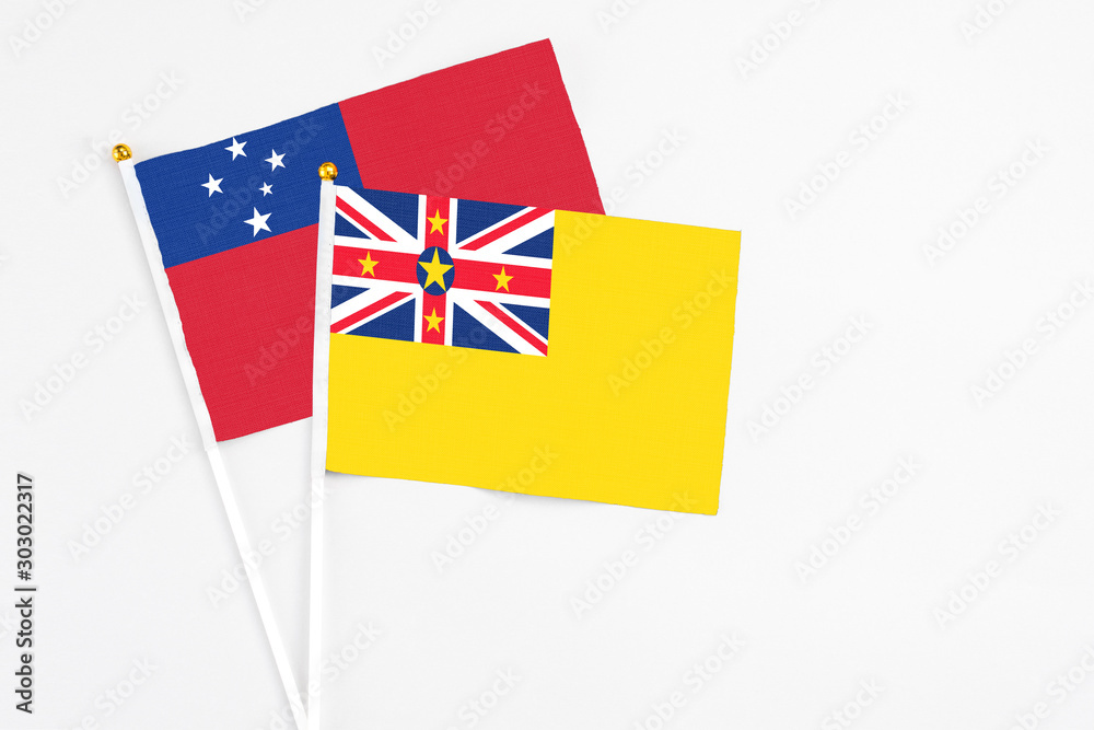 Niue and Samoa stick flags on white background. High quality fabric, miniature national flag. Peaceful global concept.White floor for copy space. Niue and Samoa stick flags on white background. High quality fabric, miniature national flag. Peaceful global concept.White floor for copy space.