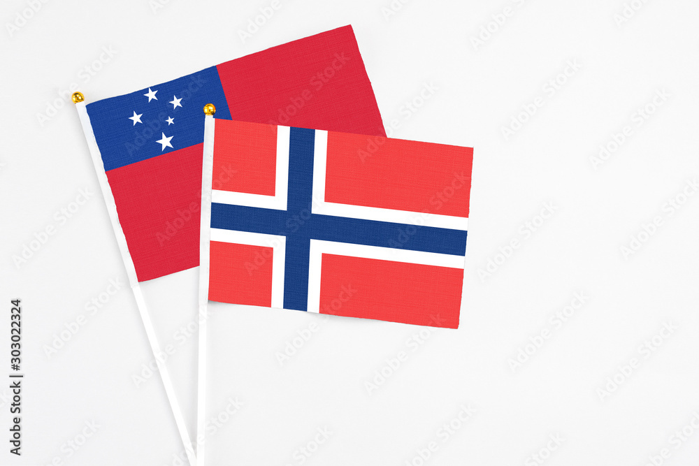 Norway and Samoa stick flags on white background. High quality fabric, miniature national flag. Peaceful global concept.White floor for copy space.