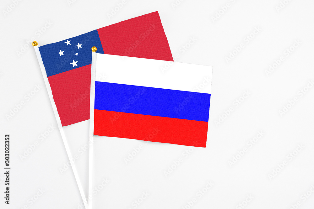 Russia and Samoa stick flags on white background. High quality fabric, miniature national flag. Peaceful global concept.White floor for copy space. Russia and Samoa stick flags on white background. High quality fabric, miniature national flag. Peaceful global concept.White floor for copy space.