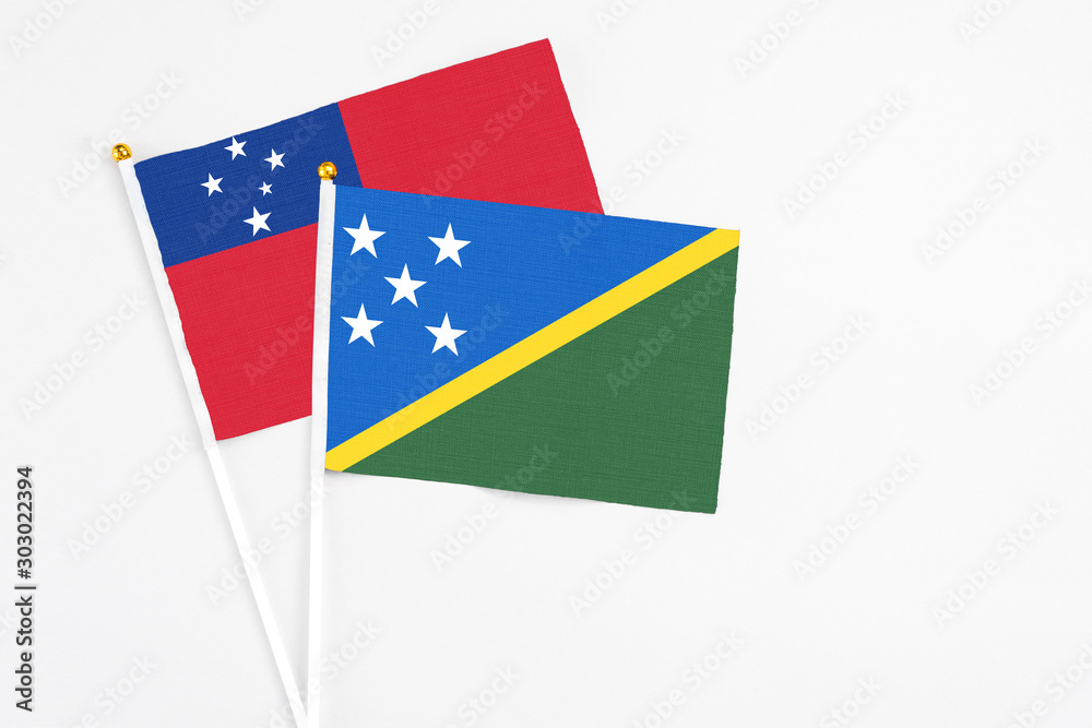 Solomon Islands and Samoa stick flags on white background. High quality fabric, miniature national flag. Peaceful global concept.White floor for copy space. Solomon Islands and Samoa stick flags on white background. High quality fabric, miniature national flag. Peaceful global concept.White floor for copy space.
