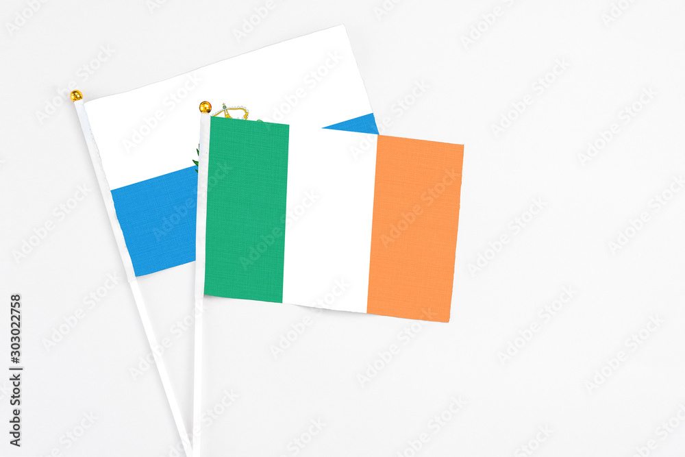 Ireland and San Marino stick flags on white background. High quality fabric, miniature national flag. Peaceful global concept.White floor for copy space. Ireland and San Marino stick flags on white background. High quality fabric, miniature national flag. Peaceful global concept.White floor for copy space.