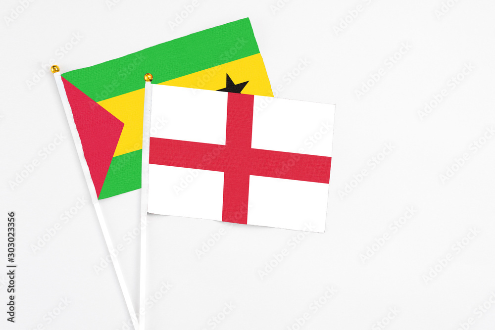 England and Sao Tome And Principe stick flags on white background. High quality fabric, miniature national flag. Peaceful global concept.White floor for copy space.