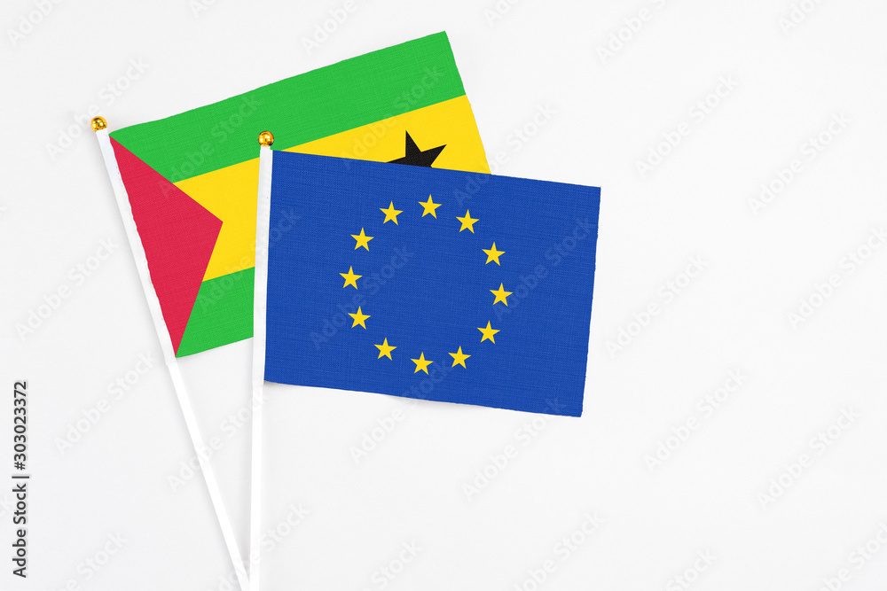 European Union and Sao Tome And Principe stick flags on white background. High quality fabric, miniature national flag. Peaceful global concept.White floor for copy space. European Union and Sao Tome And Principe stick flags on white background. High quality fabric, miniature national flag. Peaceful global concept.White floor for copy space.