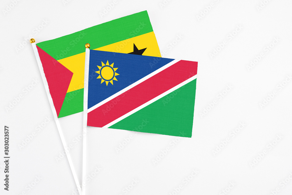 Namibia and Sao Tome And Principe stick flags on white background. High quality fabric, miniature national flag. Peaceful global concept.White floor for copy space. Namibia and Sao Tome And Principe stick flags on white background. High quality fabric, miniature national flag. Peaceful global concept.White floor for copy space.