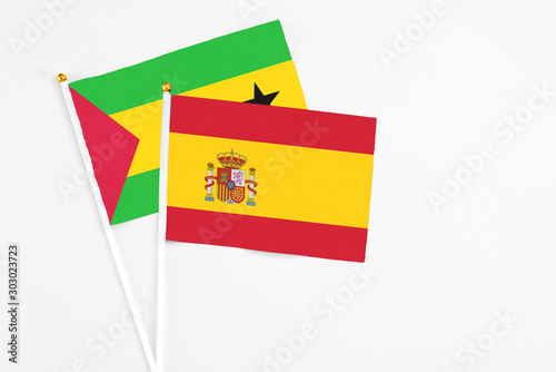 Spain and Sao Tome And Principe stick flags on white background. High quality fabric  miniature national flag. Peaceful global concept.White floor for copy space.