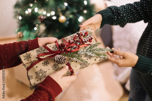 Woman giving decorated present to a child