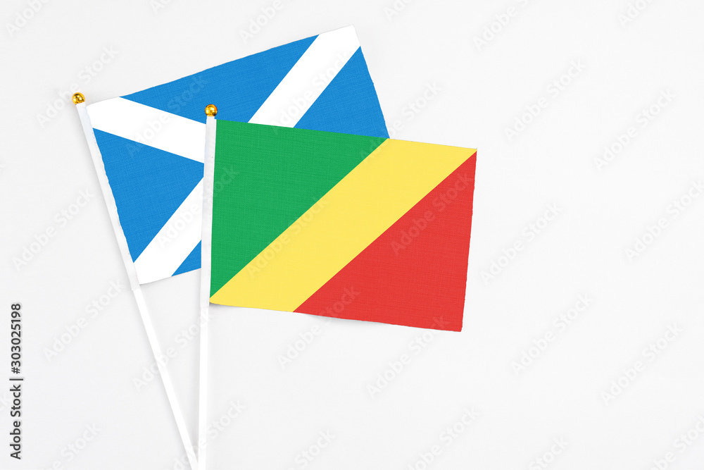Republic Of The Congo and Scotland stick flags on white background. High quality fabric, miniature national flag. Peaceful global concept.White floor for copy space.