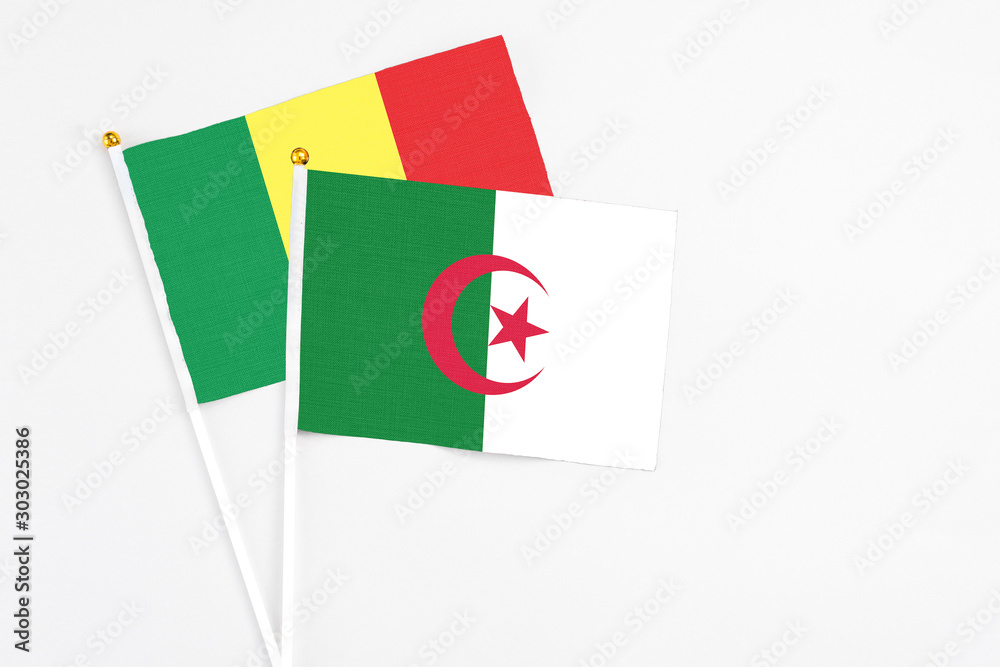 Algeria and Senegal stick flags on white background. High quality fabric, miniature national flag. Peaceful global concept.White floor for copy space. Algeria and Senegal stick flags on white background. High quality fabric, miniature national flag. Peaceful global concept.White floor for copy space.