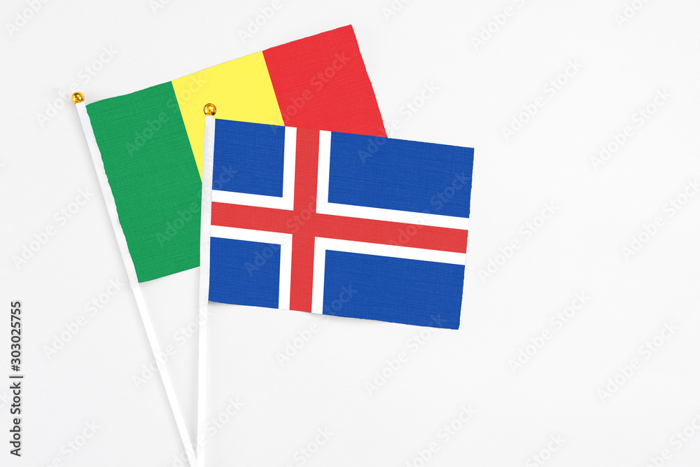 Iceland and Senegal stick flags on white background. High quality fabric, miniature national flag. Peaceful global concept.White floor for copy space.