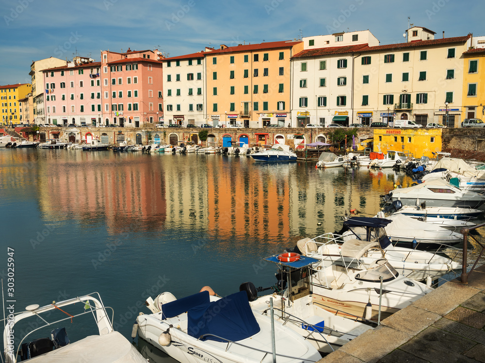 channel with boats and view to coloured houses in in Livorno in Tuscany in Italy