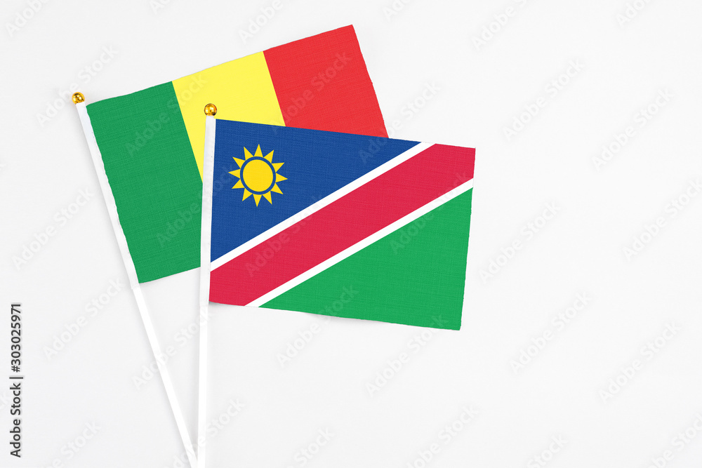 Namibia and Senegal stick flags on white background. High quality fabric, miniature national flag. Peaceful global concept.White floor for copy space.