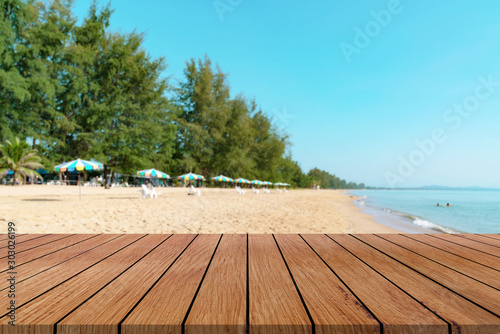 Wooden table with beach landscape blur Background
