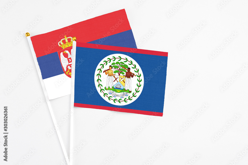 Belize and Serbia stick flags on white background. High quality fabric, miniature national flag. Peaceful global concept.White floor for copy space. Belize and Serbia stick flags on white background. High quality fabric, miniature national flag. Peaceful global concept.White floor for copy space.