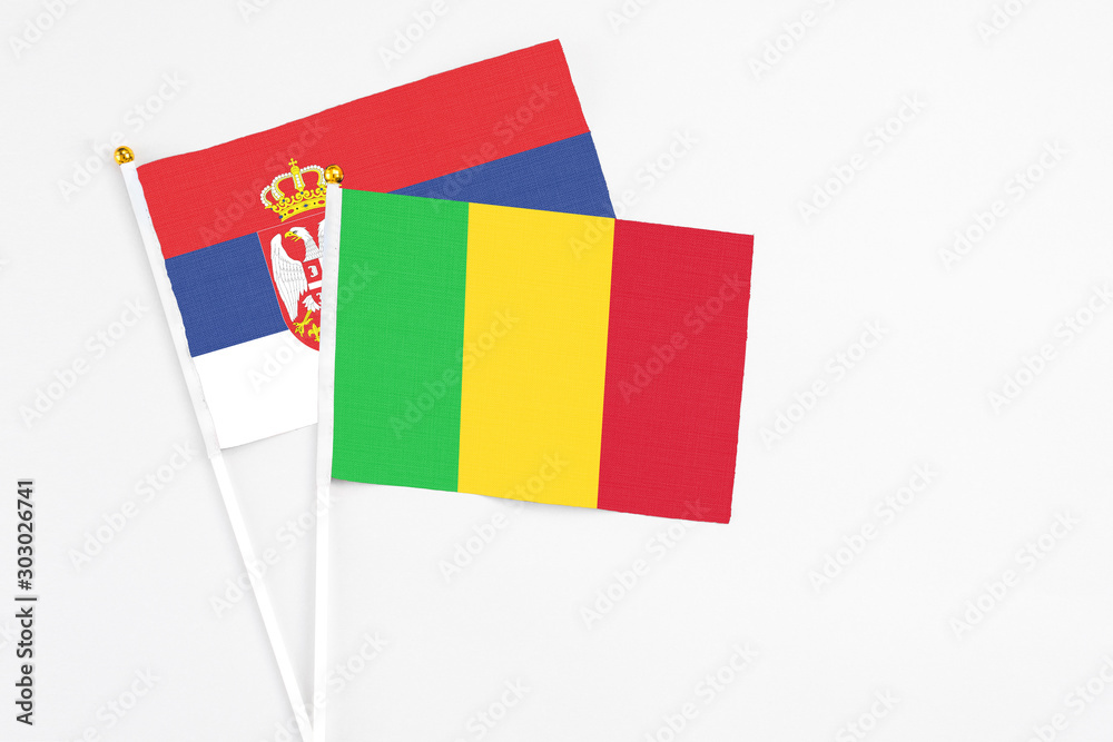 Mali and Serbia stick flags on white background. High quality fabric, miniature national flag. Peaceful global concept.White floor for copy space. Mali and Serbia stick flags on white background. High quality fabric, miniature national flag. Peaceful global concept.White floor for copy space.