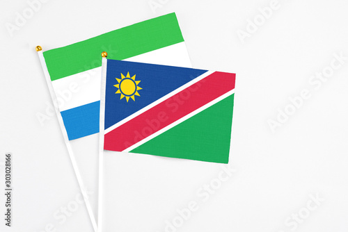 Free Download Namibia and Sierra Leone stick flags on white background. High quality fabric, miniature national flag. Peaceful global concept.White floor for copy space. - GFXLoad