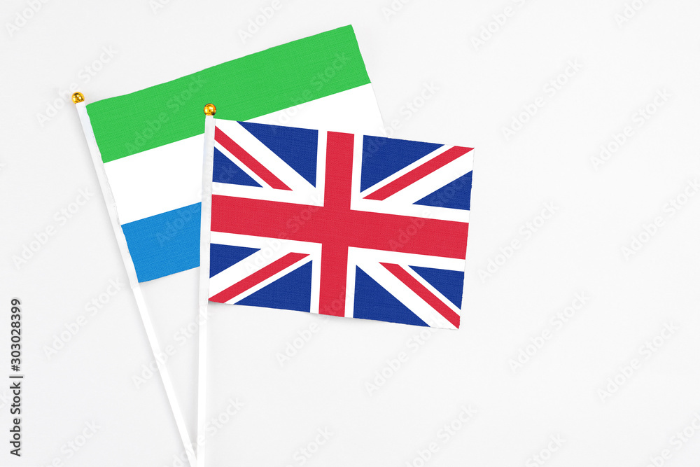 United Kingdom and Sierra Leone stick flags on white background. High quality fabric, miniature national flag. Peaceful global concept.White floor for copy space. United Kingdom and Sierra Leone stick flags on white background. High quality fabric, miniature national flag. Peaceful global concept.White floor for copy space.