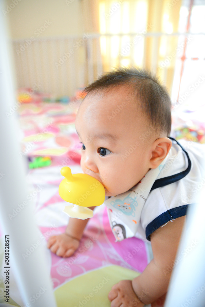 Cute Asian little baby boy chewing teething Cute Asian little baby boy chewing teething