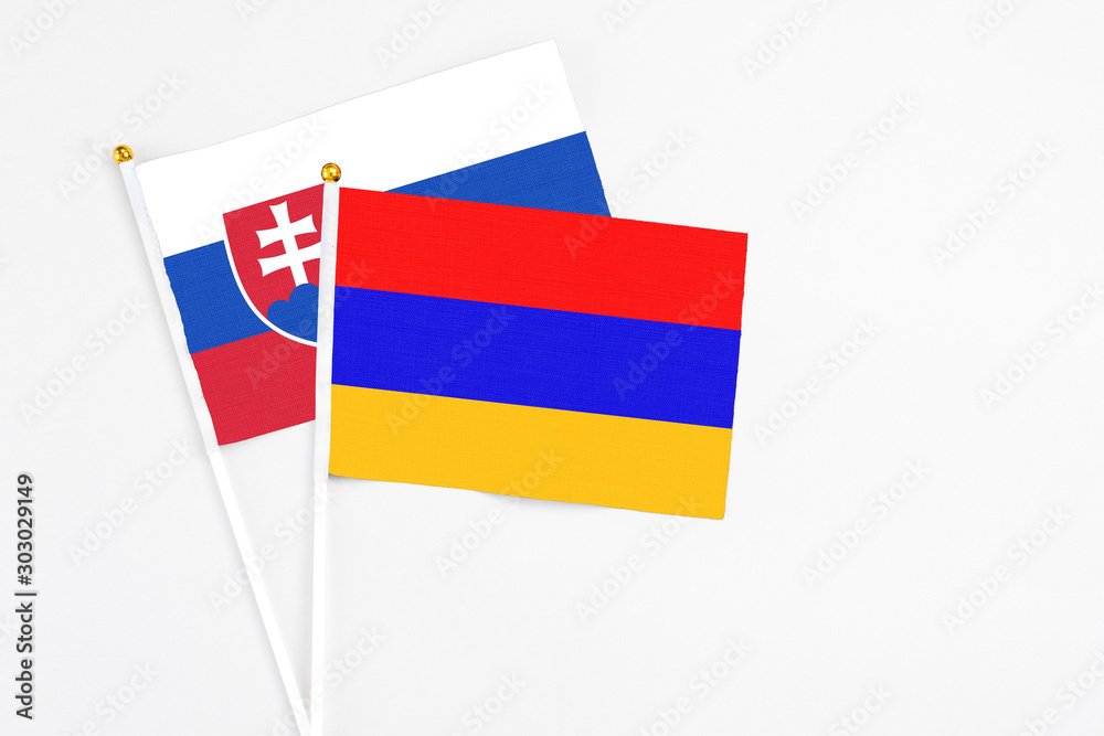 Armenia and Slovakia stick flags on white background. High quality fabric, miniature national flag. Peaceful global concept.White floor for copy space. Armenia and Slovakia stick flags on white background. High quality fabric, miniature national flag. Peaceful global concept.White floor for copy space.
