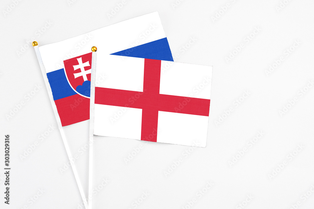 England and Slovakia stick flags on white background. High quality fabric, miniature national flag. Peaceful global concept.White floor for copy space.