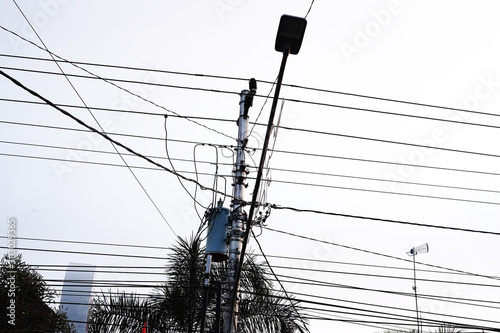 Complex roadside electrical wires with lamp post photo