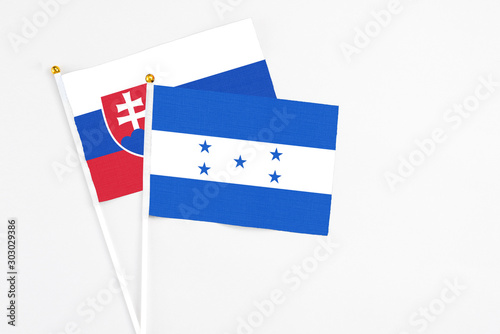 Free Download Honduras and Slovakia stick flags on white background. High quality fabric, miniature national flag. Peaceful global concept.White floor for copy space. - GFXLoad