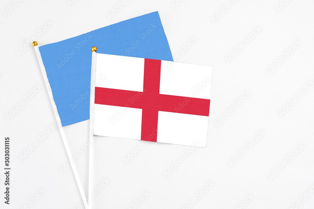 England and Somalia stick flags on white background. High quality fabric, miniature national flag. Peaceful global concept.White floor for copy space.
