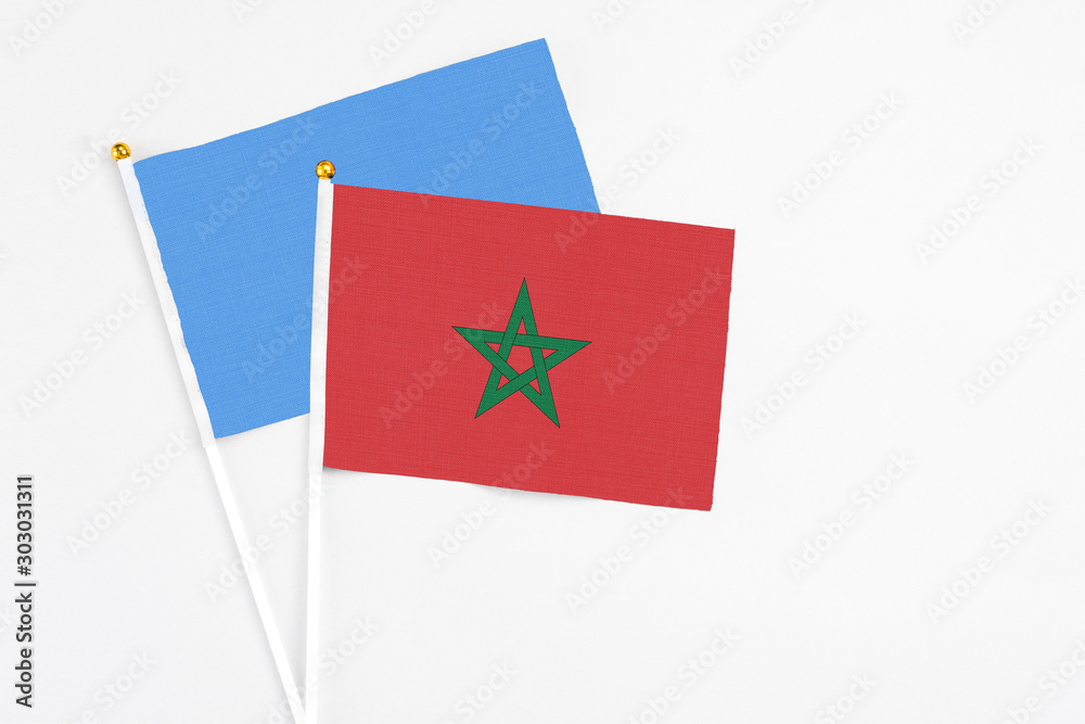 Morocco and Somalia stick flags on white background. High quality fabric, miniature national flag. Peaceful global concept.White floor for copy space. Morocco and Somalia stick flags on white background. High quality fabric, miniature national flag. Peaceful global concept.White floor for copy space.