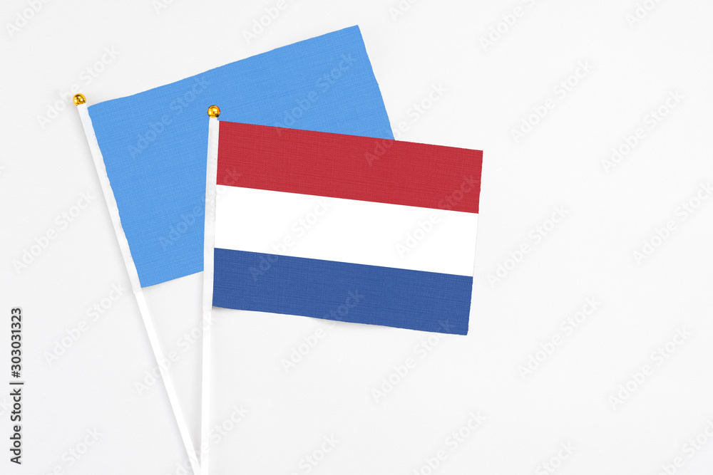 Netherlands and Somalia stick flags on white background. High quality fabric, miniature national flag. Peaceful global concept.White floor for copy space. Netherlands and Somalia stick flags on white background. High quality fabric, miniature national flag. Peaceful global concept.White floor for copy space.