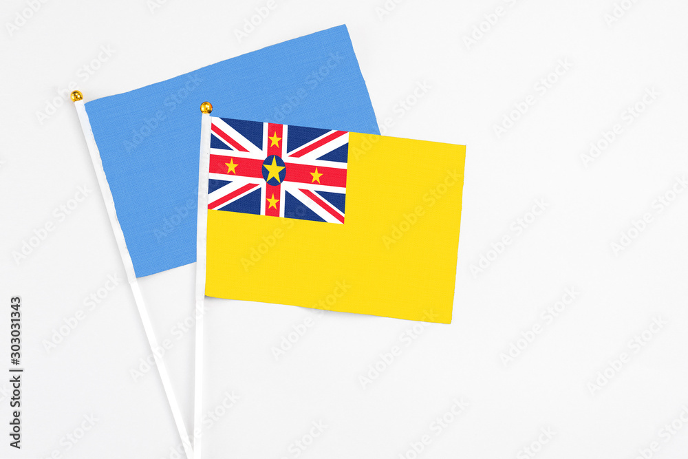 Niue and Somalia stick flags on white background. High quality fabric, miniature national flag. Peaceful global concept.White floor for copy space. Niue and Somalia stick flags on white background. High quality fabric, miniature national flag. Peaceful global concept.White floor for copy space.