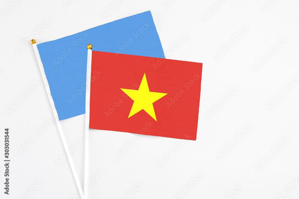 Vietnam and Somalia stick flags on white background. High quality fabric, miniature national flag. Peaceful global concept.White floor for copy space. Vietnam and Somalia stick flags on white background. High quality fabric, miniature national flag. Peaceful global concept.White floor for copy space.