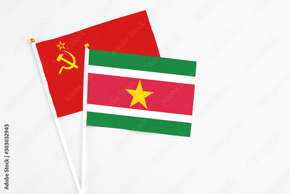 Suriname and Soviet Union stick flags on white background. High quality fabric, miniature national flag. Peaceful global concept.White floor for copy space. Suriname and Soviet Union stick flags on white background. High quality fabric, miniature national flag. Peaceful global concept.White floor for copy space.