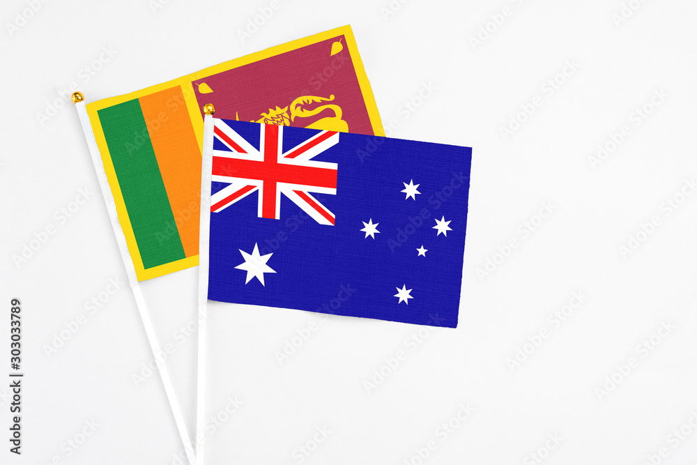 Fototapeta premium and Sri Lanka stick flags on white background. High quality fabric, miniature national flag. Peaceful global concept.White floor for copy space.