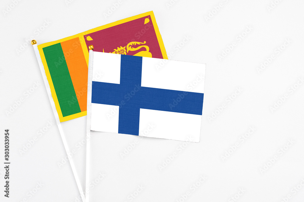 and Sri Lanka stick flags on white background. High quality fabric, miniature national flag. Peaceful global concept.White floor for copy space.
