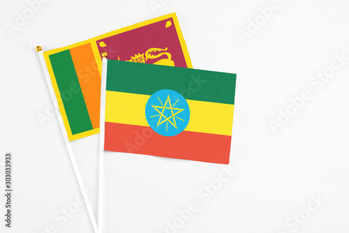 and Sri Lanka stick flags on white background. High quality fabric  miniature national flag. Peaceful global concept.White floor for copy space.