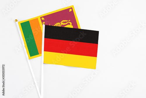 and Sri Lanka stick flags on white background. High quality fabric  miniature national flag. Peaceful global concept.White floor for copy space.