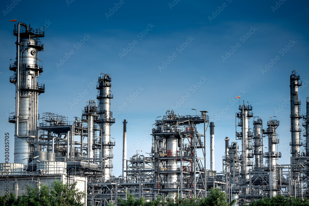 Close-up view Oil and gas industrial refinery zone,Detail of equipment oil pipeline steel with valve from large oil storage tank at cloudy sky. -image