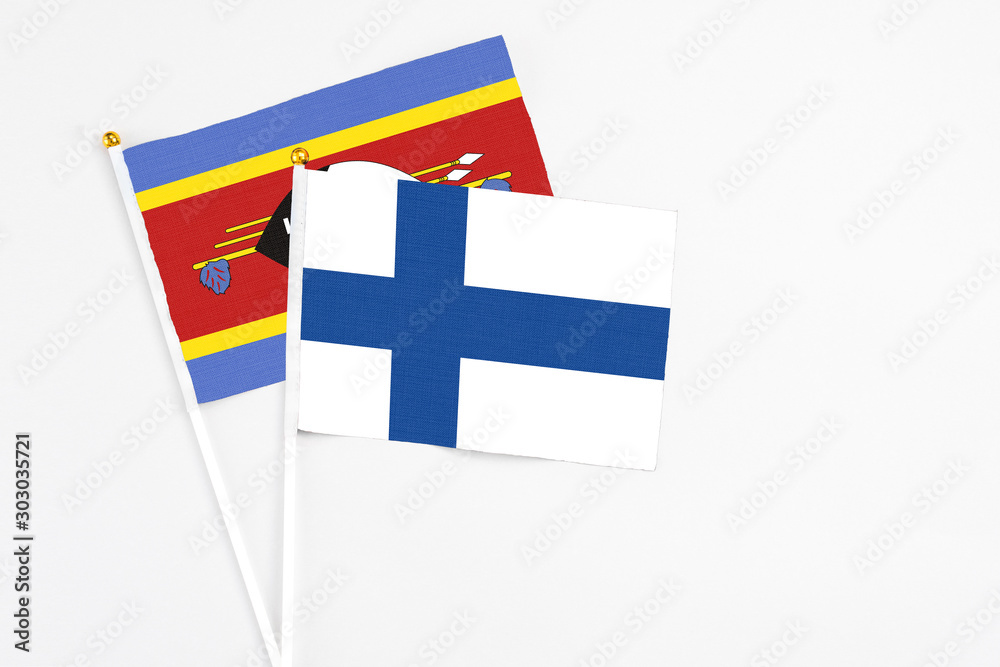Finland and Swaziland stick flags on white background. High quality fabric, miniature national flag. Peaceful global concept.White floor for copy space. Finland and Swaziland stick flags on white background. High quality fabric, miniature national flag. Peaceful global concept.White floor for copy space.