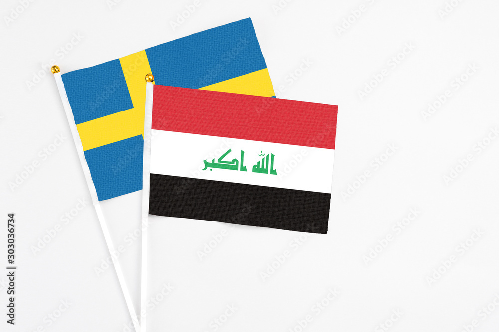 Iraq and Sweden stick flags on white background. High quality fabric, miniature national flag. Peaceful global concept.White floor for copy space. Iraq and Sweden stick flags on white background. High quality fabric, miniature national flag. Peaceful global concept.White floor for copy space.