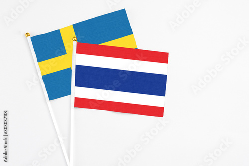 Thailand and Sweden stick flags on white background. High quality fabric, miniature national flag. Peaceful global concept.White floor for copy space. Free Download Thailand and Sweden stick flags on white background. High quality fabric, miniature national flag. Peaceful global concept.White floor for copy space. - GFXLoad