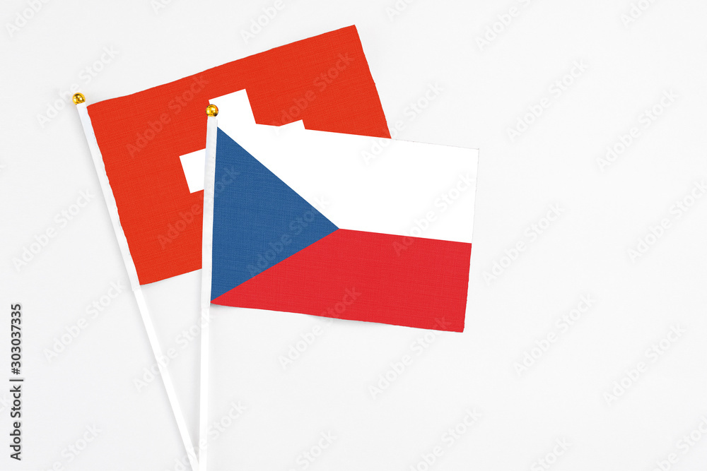 Czech Republic and Switzerland stick flags on white background. High quality fabric, miniature national flag. Peaceful global concept.White floor for copy space.