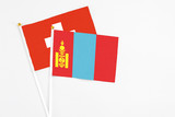 Mongolia and Switzerland stick flags on white background. High quality fabric, miniature national flag. Peaceful global concept.White floor for copy space.