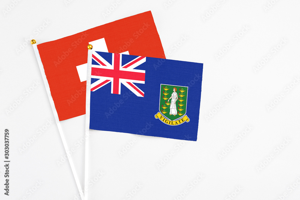 British Virgin Islands and Switzerland stick flags on white background. High quality fabric, miniature national flag. Peaceful global concept.White floor for copy space. British Virgin Islands and Switzerland stick flags on white background. High quality fabric, miniature national flag. Peaceful global concept.White floor for copy space.
