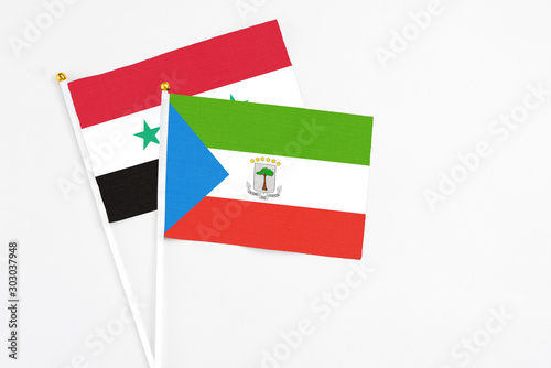 Equatorial Guinea and Syria stick flags on white background. High quality fabric, miniature national flag. Peaceful global concept.White floor for copy space.